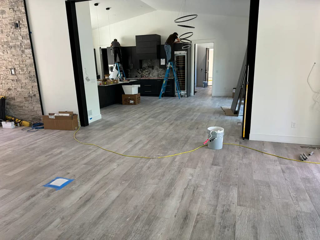 Wide view of an open-concept luxury home in Black Forest, CO, featuring continuous wood-look porcelain tile flooring installation by XCEL TILE.